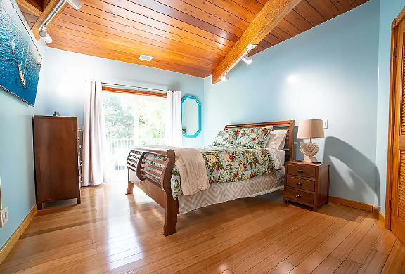 Downstairs Bedroom has a Queen Size Bed and a Separate Porch/Balcony